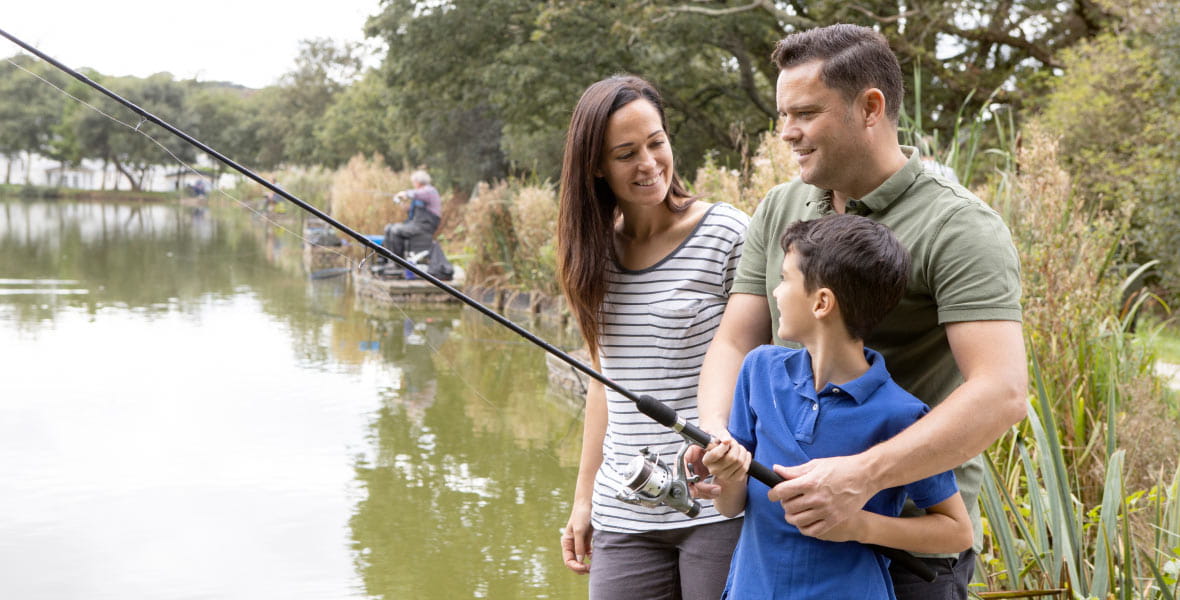 a mother and father with their son fishing