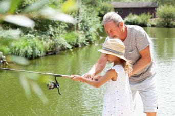 a father with his daughter fishing