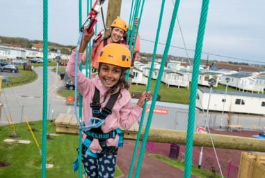child on high ropes smiling