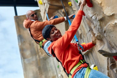 adults on a climbing wall