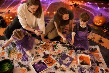 Children playing with Halloween crafts