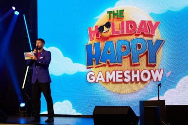Man presenting gameshow on stage