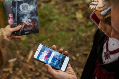 People in fancy dress holding phones