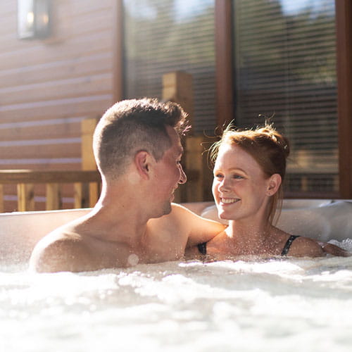 A couple relaxing in their hot tub