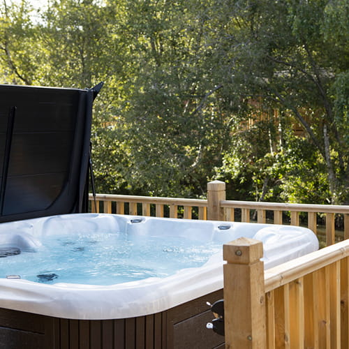 A hot tub on a lodge veranda