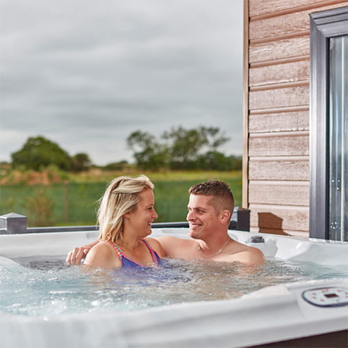 A couple relaxing in their hot tub
