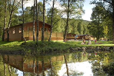 Lodges on the river at Tummel Valley Holiday Park in Scotland
