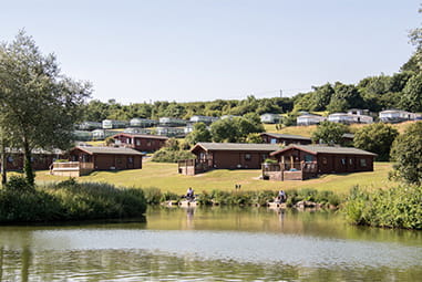 Lodges overlooking the lake at White Acres Holiday Park in Cornwall