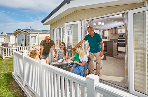 A family relaxing on their caravan veranda