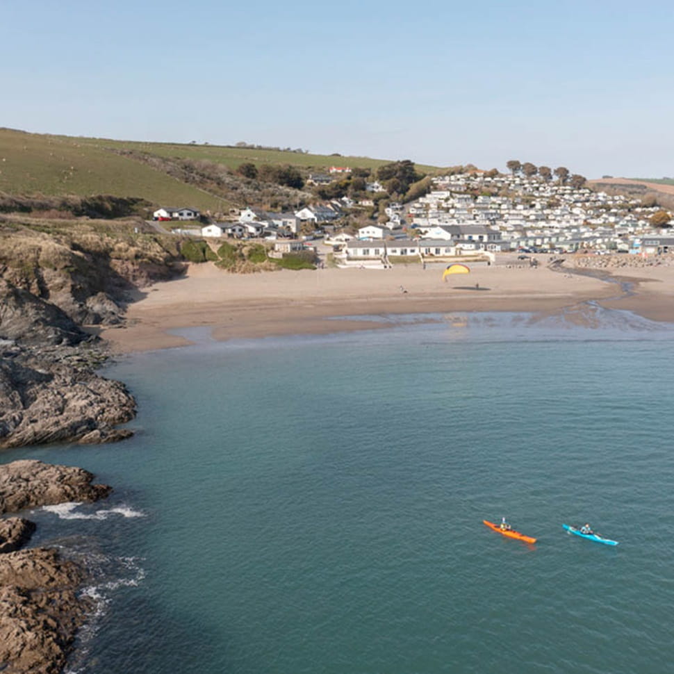 a coastal scene with beach, sea and coastal cliffs