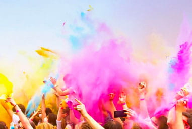 people throwing powder paint