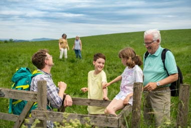family at a gate on a countryside walk