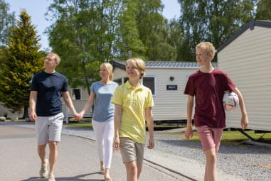 a family walking down a path of a holiday park