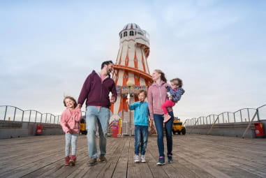 Family walking next to Clacton Pier Essex