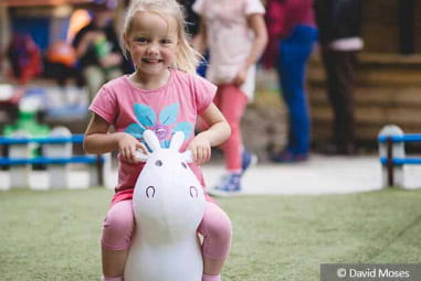 Little girl on inflatable horse