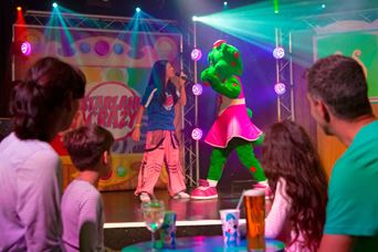 Young family watching a performance on stage at Parkdean Resorts