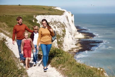 Family walking along the cliff edge