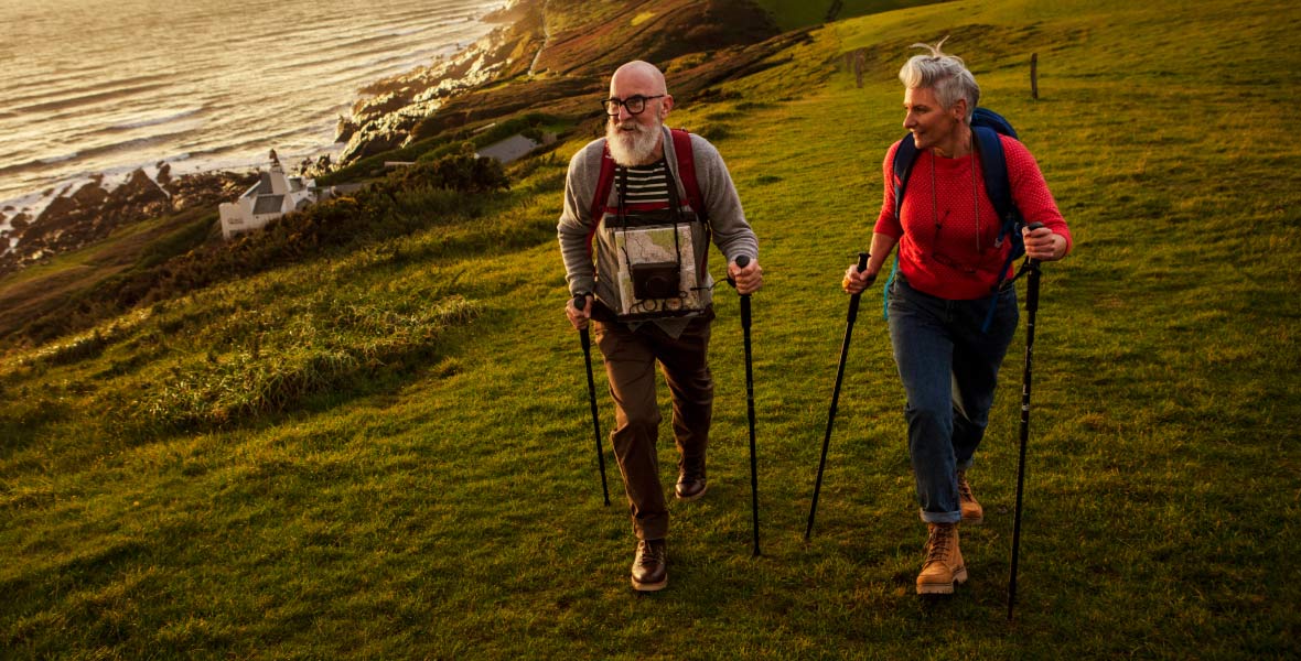 Couple walking with hiking sticks