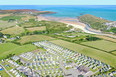A drone shot of Crantock Beach Holiday Park and Crantock Beach in Cornwall near Newquay