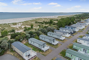 Caravans overlooking the sand dunes at Nairn Lochloy Holiday Park in Scotland