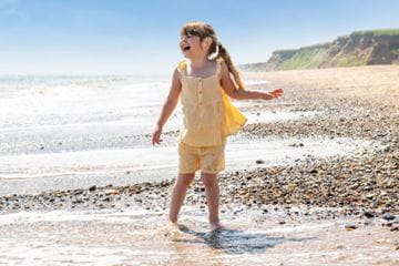 Little girl on beach smiling