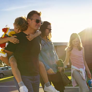 Family walking at sunset