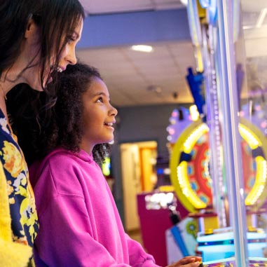 Parent and child playing in arcade
