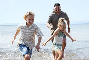 Family running on beach