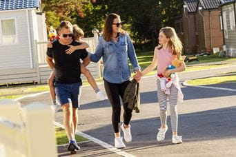 Family walking by caravans