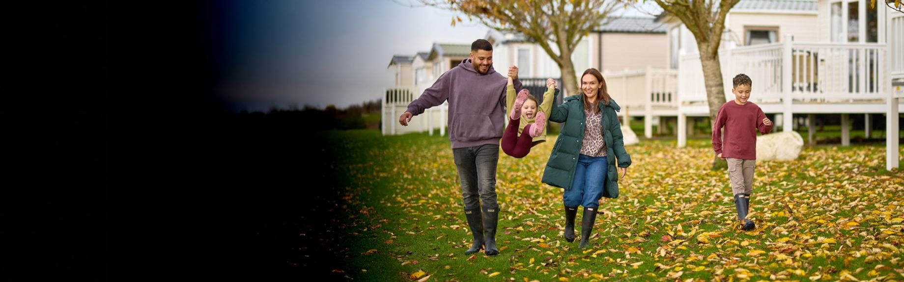 Family walking by caravans in autumn