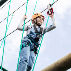 A boy climbing on the high ropes course at a Parkdean Resorts Action-Packed holiday park