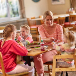 A young family sitting down for a meal in a restaurant