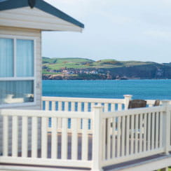 A caravan with a veranda overlooking a spectacular bay