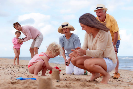 A family building a sandcastle on the beach