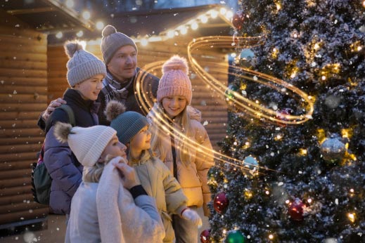 A family looking at a Christmas tree on a Parkdean Resorts Christmas break