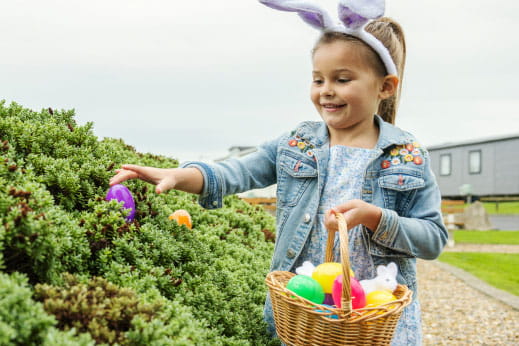 A girl hunting for Easter eggs on a Parkdean Resorts Easter break activity