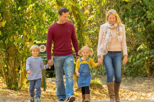 A family on an autumn walk in the woods