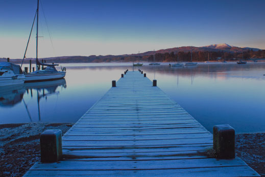 A frosty winter morning looking along a pier leading into Lake Windermere