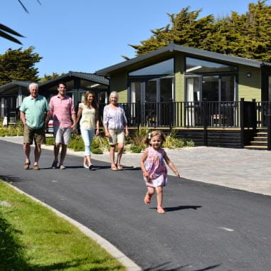 A family leaving their luxury lodge at a Parkdean Resorts holiday park