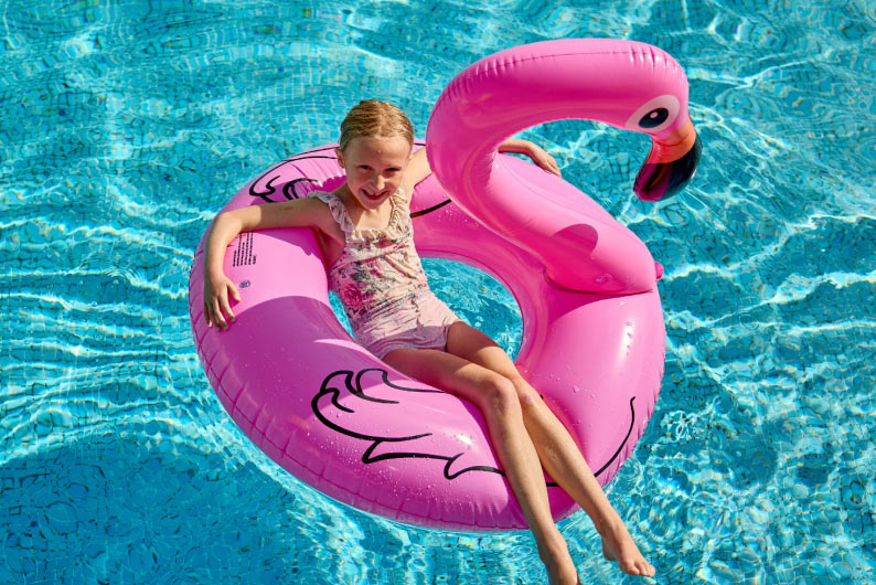 Pink inflatable flamingo in a pool