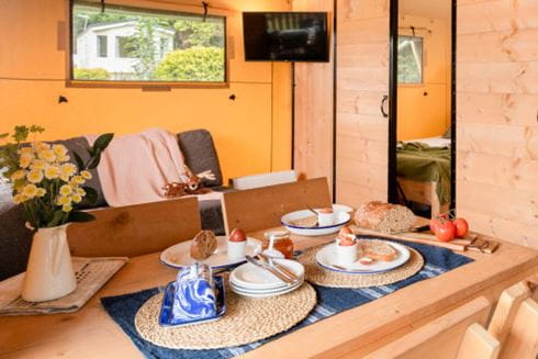 Glamping pod with dining table set for four people