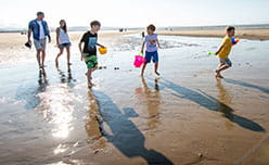 Ty Mawr hero image of a family playing on the beach