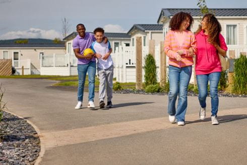 Family walking arm in arm through parkdean resorts