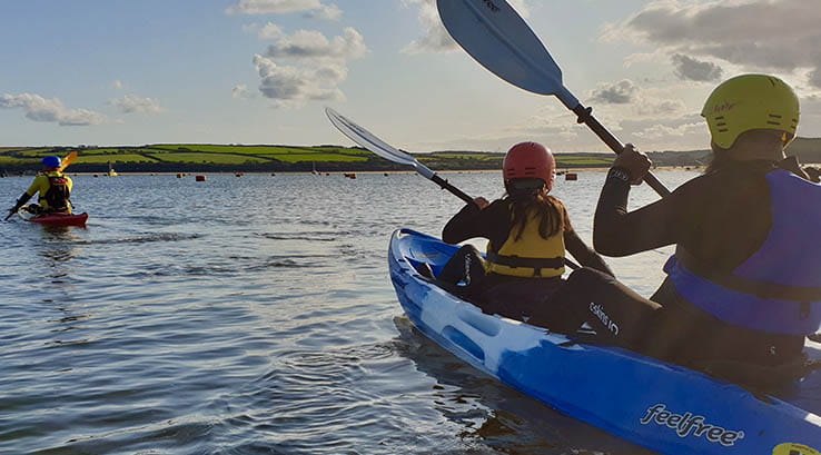 people paddling in a sea kayak