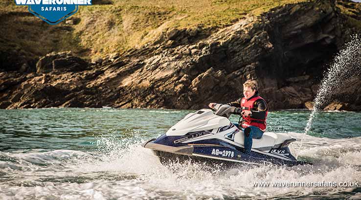 man on a jet ski around rugged coastline