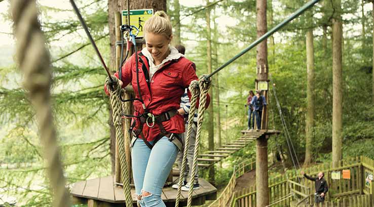 Girl walking over rope bridge