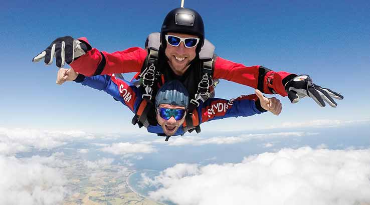 Two people sky diving