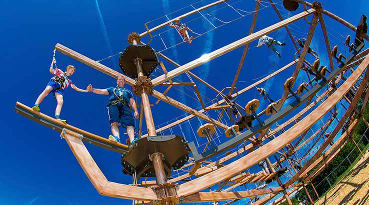 People taking part in a high ropes course