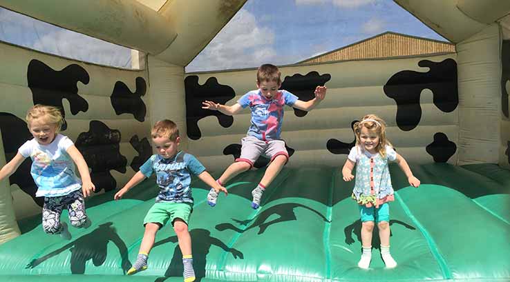 children bouncing on a bouncy castle
