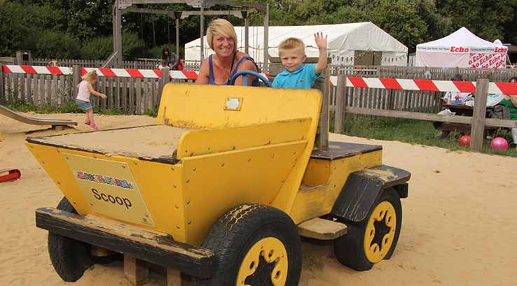 Mum and son riding dumper truck